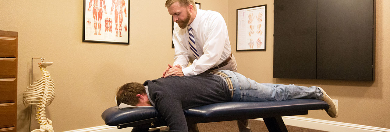 Dr. Riley works on the back and shoulders of a patient at NNC Dr. Riley works on the back and shoulders of a patient at NNC