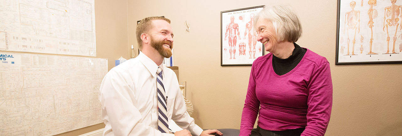 Dr. Riley and Patient discuss chiropractic treatment Dr. Riley and Patient discuss chiropractic treatment